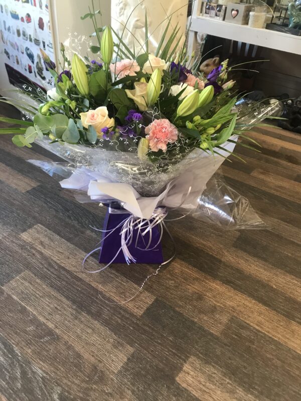 Hand tied pink, purple and white bouquet