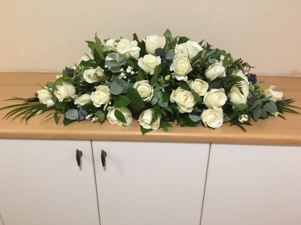 Cream rose casket tribute