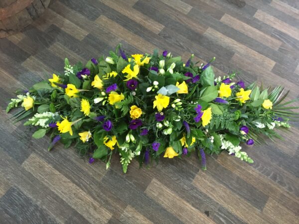 Yellow and purple with a touch of white Casket tribute